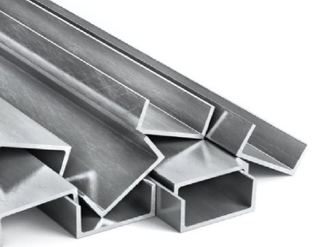 Steel angles and channels racked in the yard